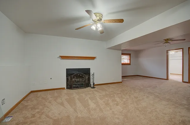 a view of a livingroom with a ceiling fan and entryway