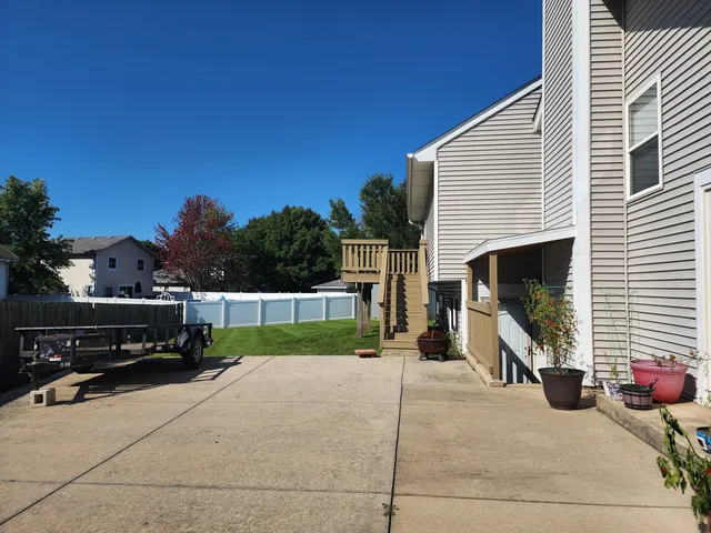a view of a house with wooden fence