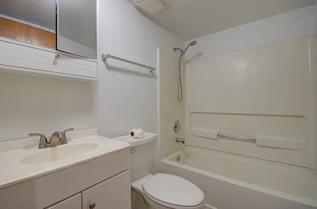 an empty room with a chandelier fan