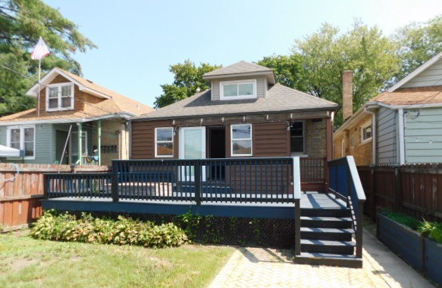 Undisclosed Address Chicago, IL 60630 - Photo 14 of 16 a front view of a house with a yard