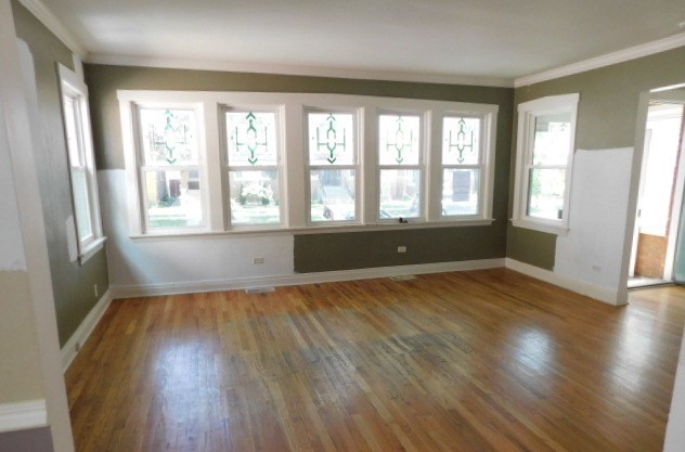 Undisclosed Address Chicago, IL 60630 - Photo 2 of 16 an empty room with wooden floor and windows