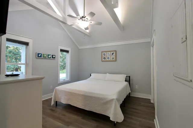 a bedroom with a bed and a chandelier