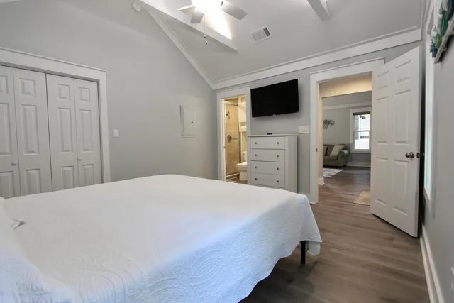 a bedroom with a bed and a flat screen tv