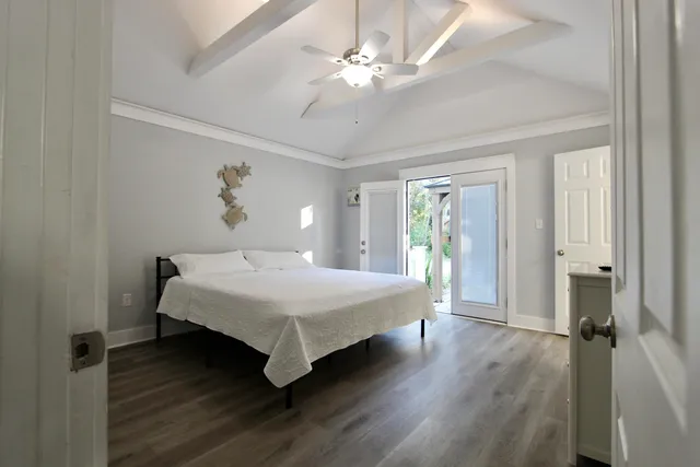 a spacious bedroom with a bed and a chandelier