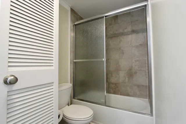 a bathroom with a shower and a toilet