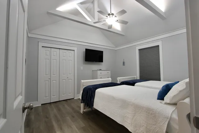 a bedroom with a bed and a ceiling fan