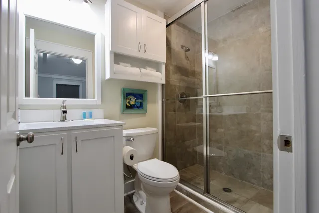 a bathroom with a sink toilet and shower