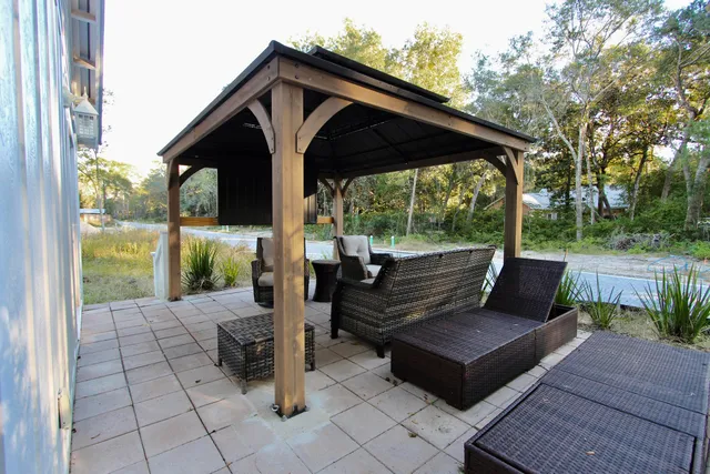 a view of a two chairs in the patio