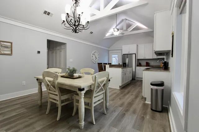 a view of a dining room with furniture and wooden floor