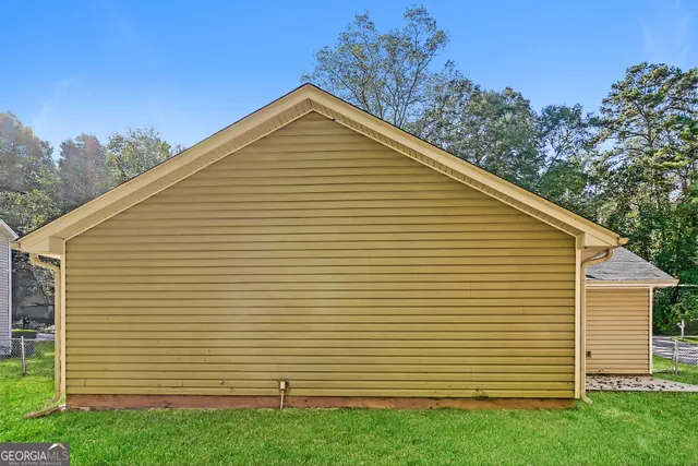 a view of a white house with a yard and garage