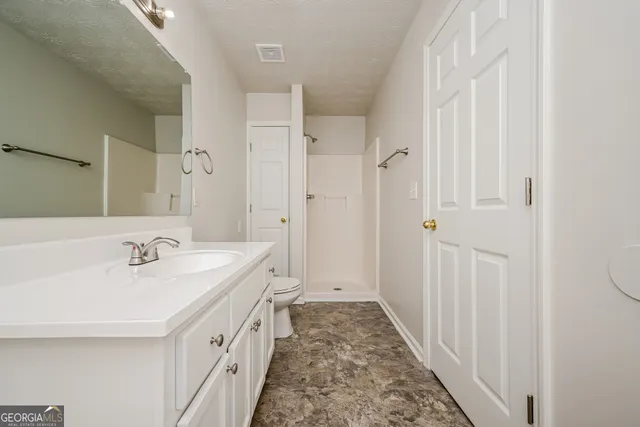a spacious bathroom with a double vanity sink and a mirror