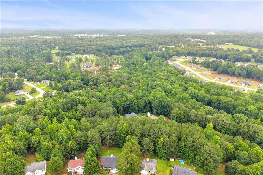 587-j B J B Owens Road Bethlehem, GA 30620 - Photo 85 of 99 an aerial view of residential houses with outdoor space and trees