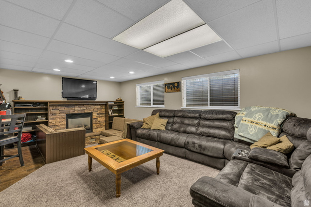 10705 Green Ridge Drive Sandy, UT 84070 - Photo 29 of 55 Living room featuring a drop ceiling, a fireplace, and wood finished floors