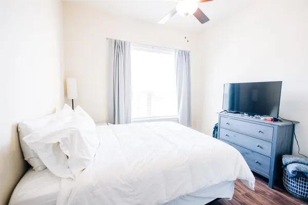 a bedroom with a bed and flat screen tv