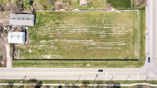 a view of a house with a yard and sitting area