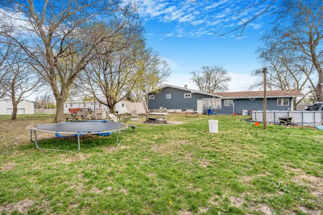 a big house with a big yard and large trees