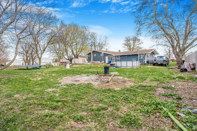 a view of a big yard with a house in the background