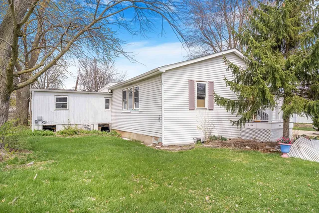 a view of yard with small cabin and wooden fence