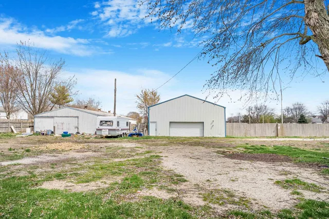 a white house that has a tree in front of it