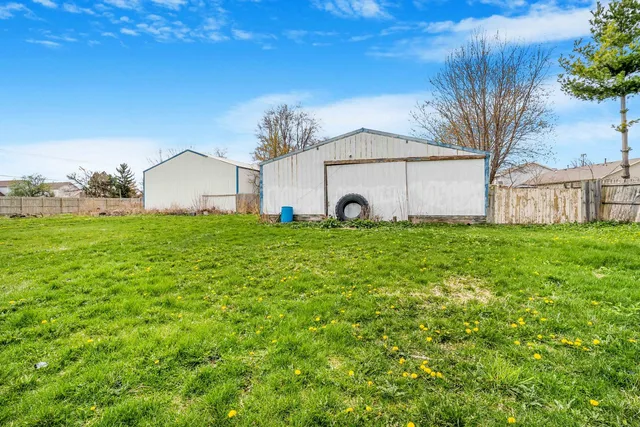 a view of a house with a garden and pathway