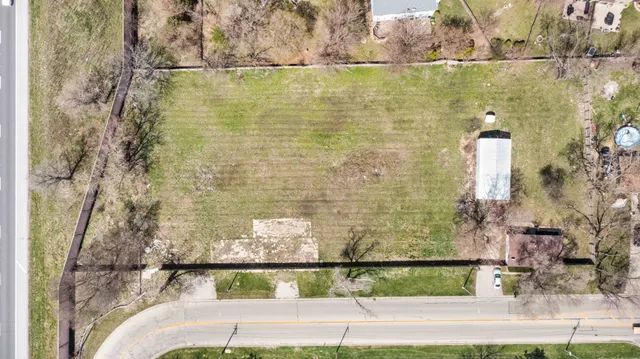 front view of house with a yard and trees
