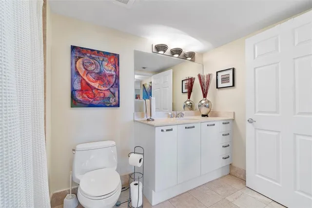 a bathroom with a toilet a sink and a mirror