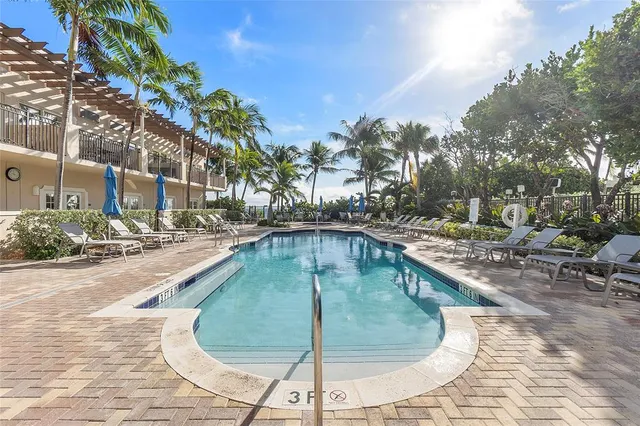 a swimming pool with outdoor seating and yard