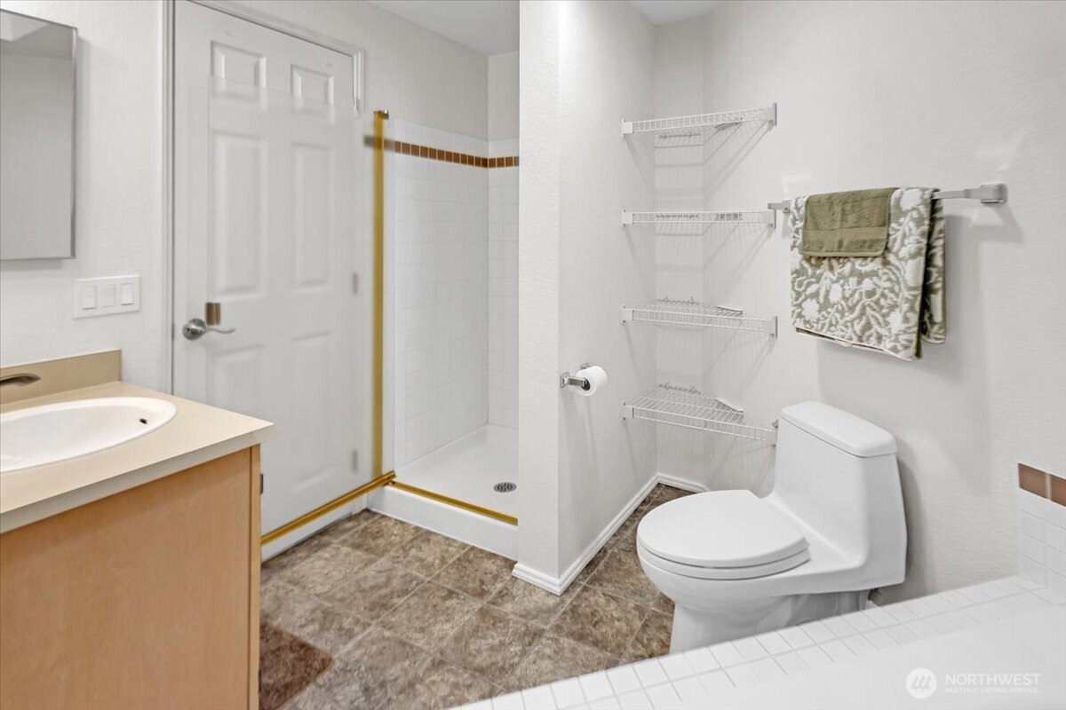 8653 Avondale Road Northeast, Unit D208 Redmond, WA 98052 - Photo 19 of 32 a bathroom with a sink a toilet and shower