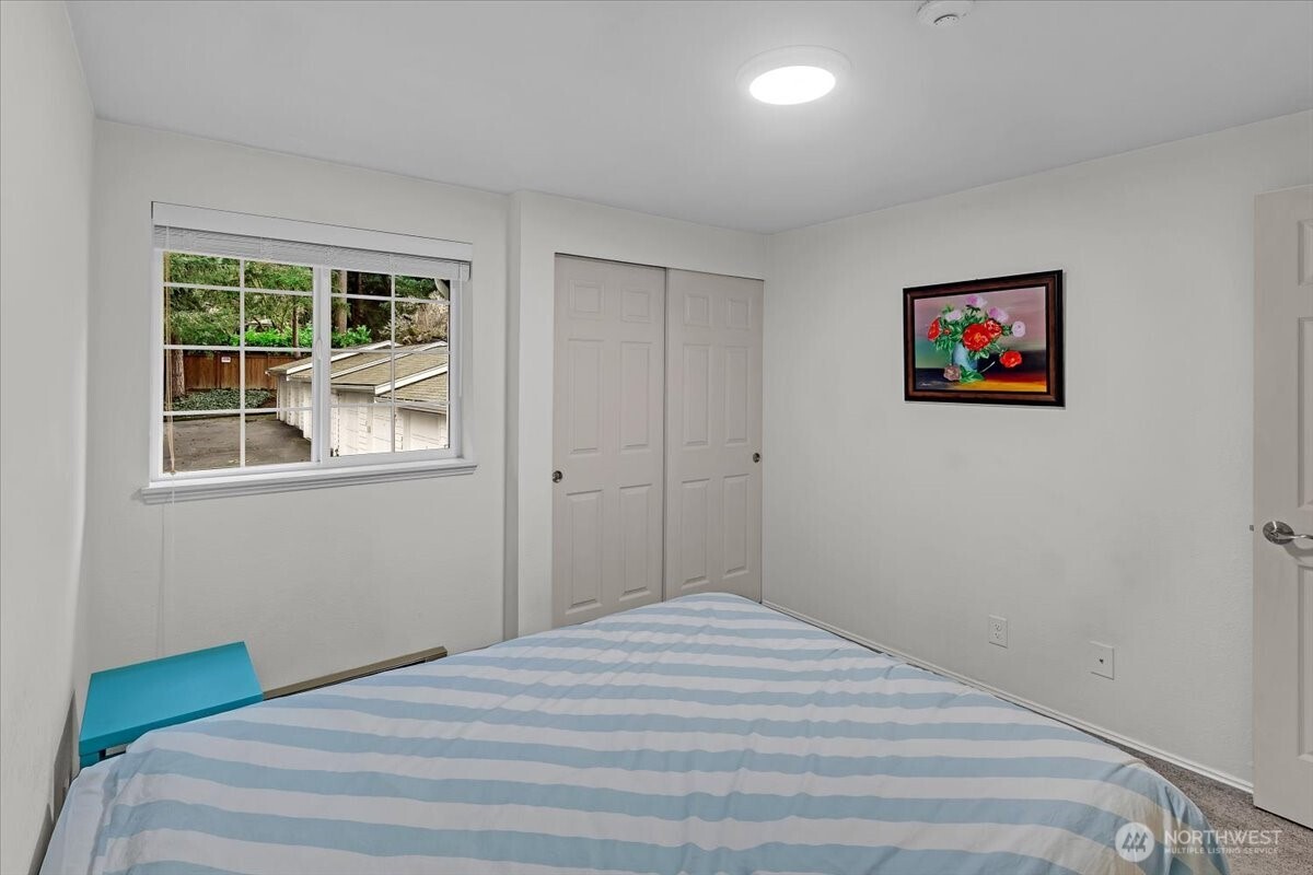 8653 Avondale Road Northeast, Unit D208 Redmond, WA 98052 - Photo 24 of 32 a bedroom with a bed and a window