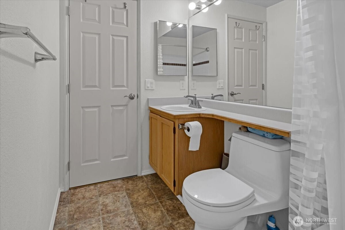 8653 Avondale Road Northeast, Unit D208 Redmond, WA 98052 - Photo 28 of 32 a bathroom with a sink a toilet and shower