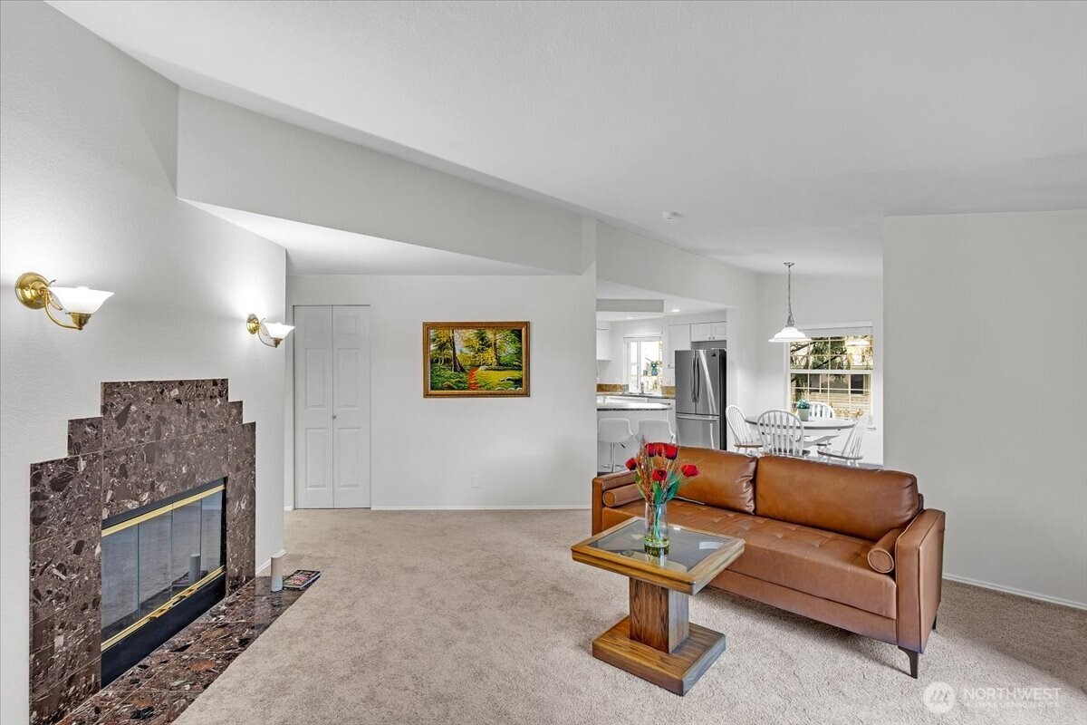 8653 Avondale Road Northeast, Unit D208 Redmond, WA 98052 - Photo 3 of 32 a living room with furniture and a fireplace