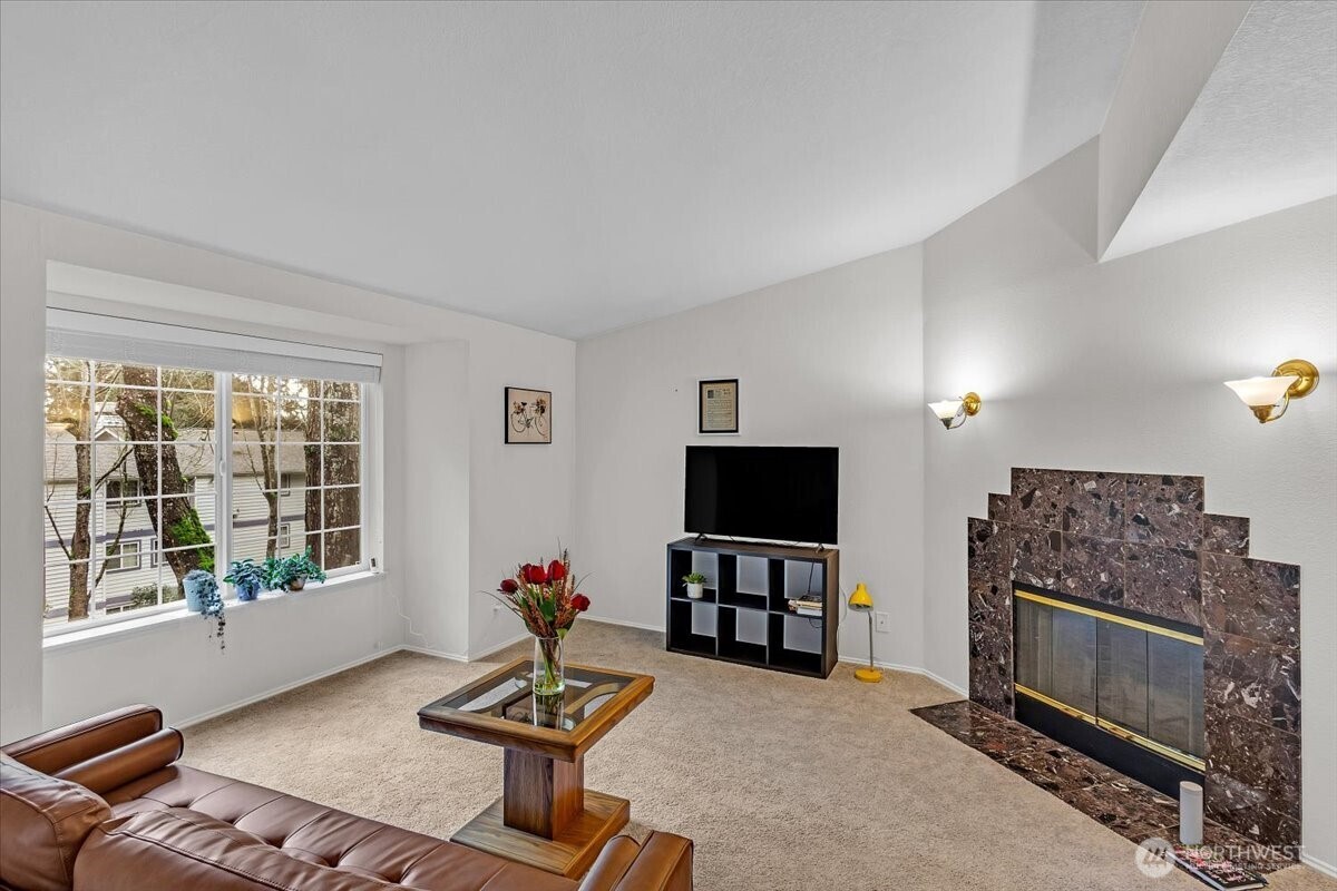 8653 Avondale Road Northeast, Unit D208 Redmond, WA 98052 - Photo 4 of 32 a living room with furniture a window and a flat screen tv