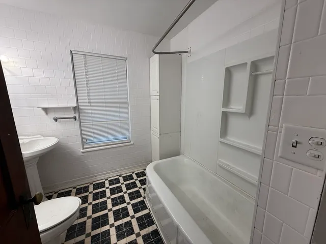 a bathroom with a bathtub and shower