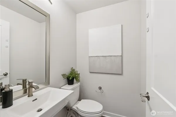 a bathroom with a sink toilet and mirror