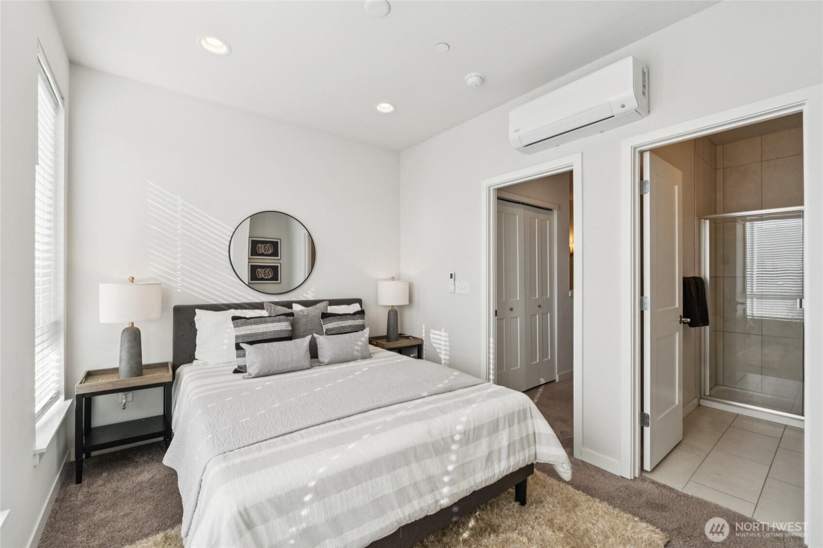 10942 Northeast 189th Place, Unit E Bothell, WA 98011 - Photo 13 of 24 a bedroom with a bed and a cabinets