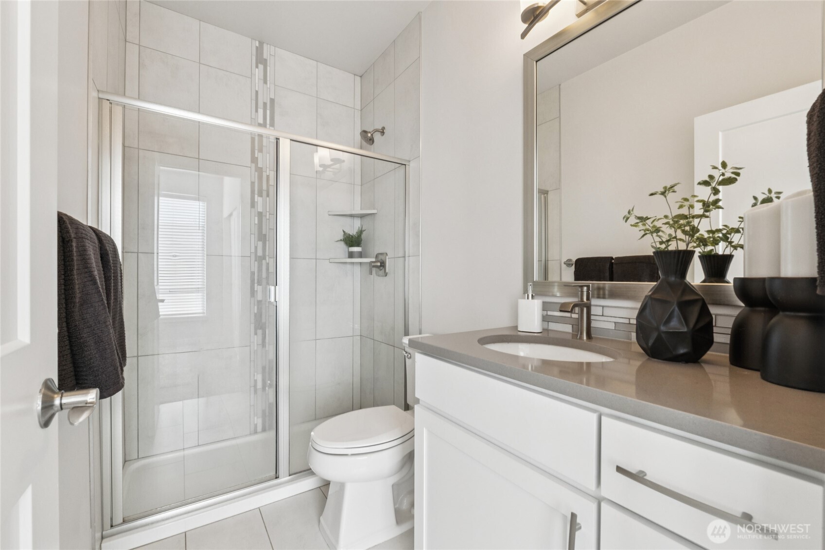 10942 Northeast 189th Place, Unit E Bothell, WA 98011 - Photo 14 of 24 a bathroom with a granite countertop sink a toilet and a shower