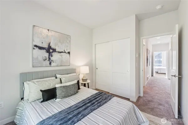 a bedroom with a bed and a painting on the wall
