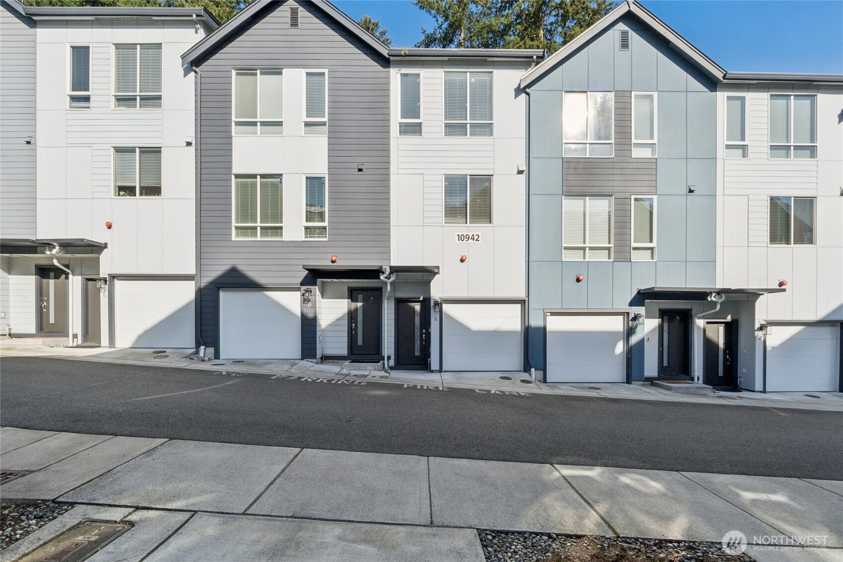 10942 Northeast 189th Place, Unit E Bothell, WA 98011 - Photo 23 of 24 a front view of a house with large windows