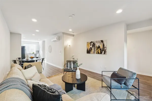 a living room with furniture and a dining table