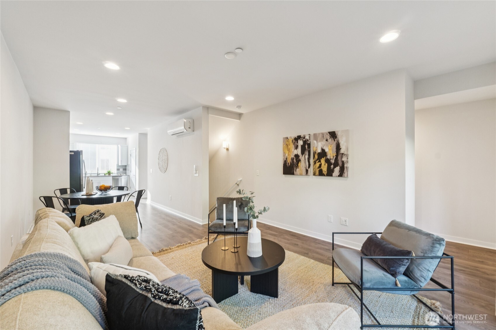 10942 Northeast 189th Place, Unit E Bothell, WA 98011 - Photo 5 of 24 a living room with furniture and a dining table