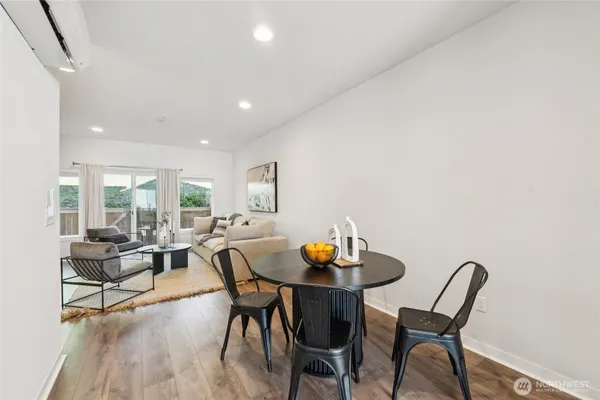 a view of a dining room with furniture and wooden floor