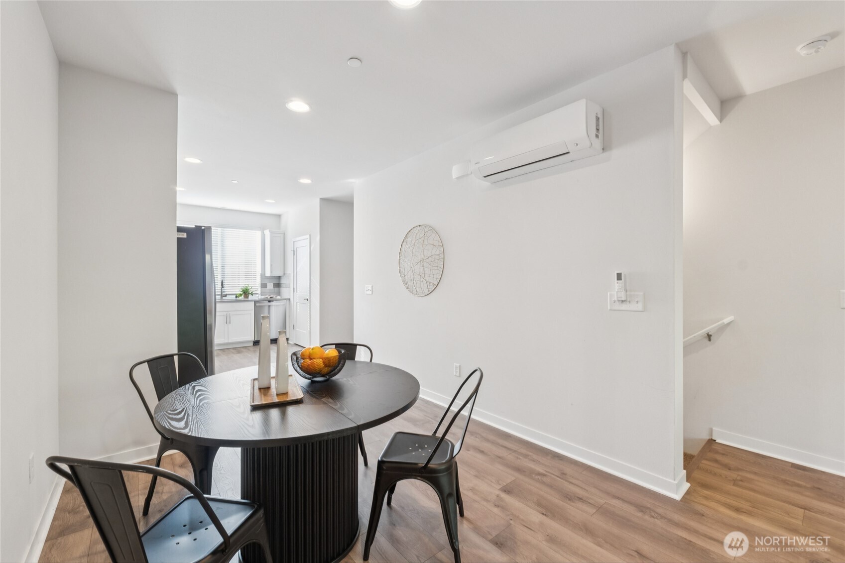 10942 Northeast 189th Place, Unit E Bothell, WA 98011 - Photo 7 of 24 a view of a dining room with table and chairs