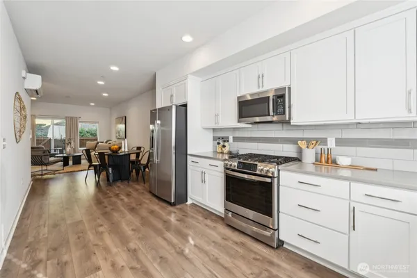 a kitchen with refrigerator and cabinets