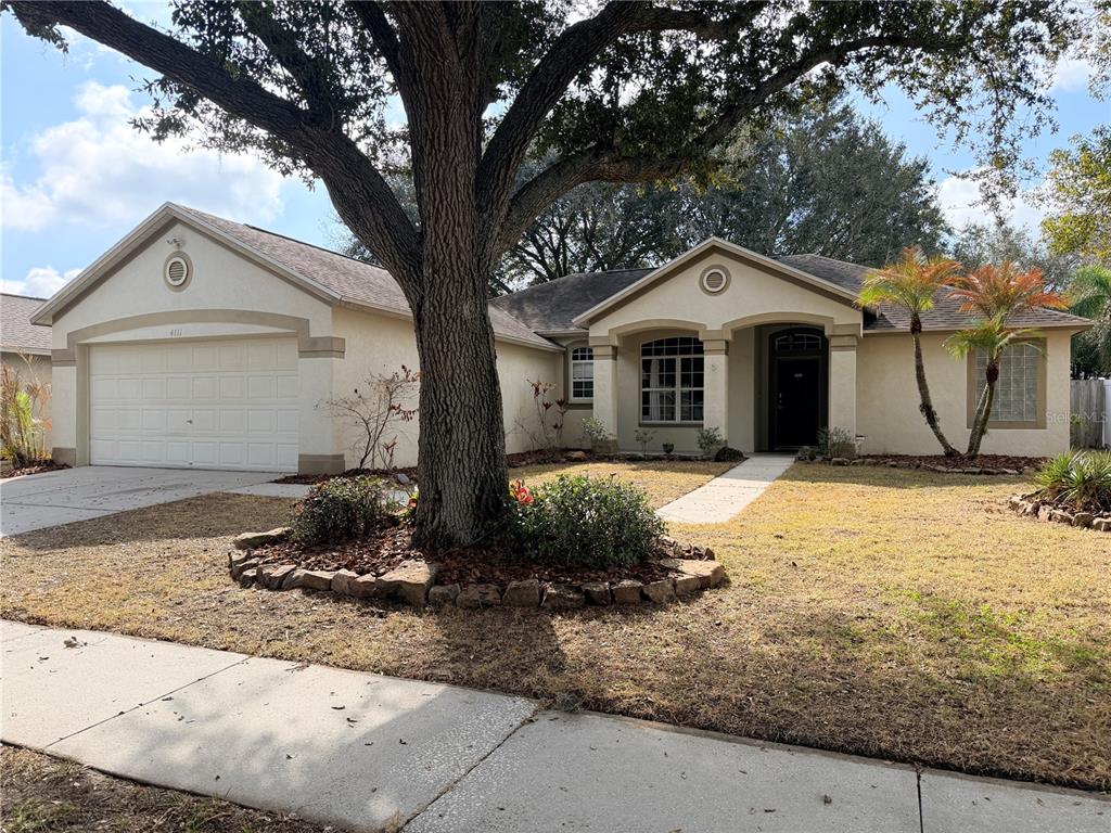 4111 Amber Ridge Lane Valrico, FL 33594 - Photo 1 of 27 a front view of a house with a yard