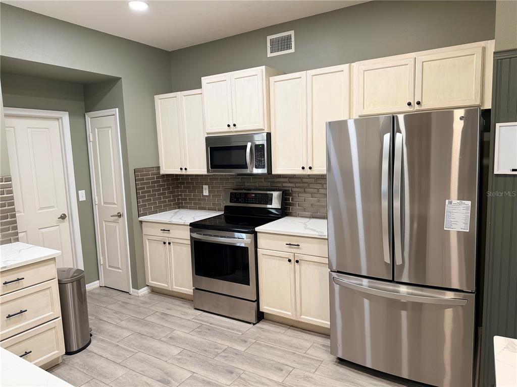 4111 Amber Ridge Lane Valrico, FL 33594 - Photo 12 of 27 a kitchen with stainless steel appliances a refrigerator sink and microwave