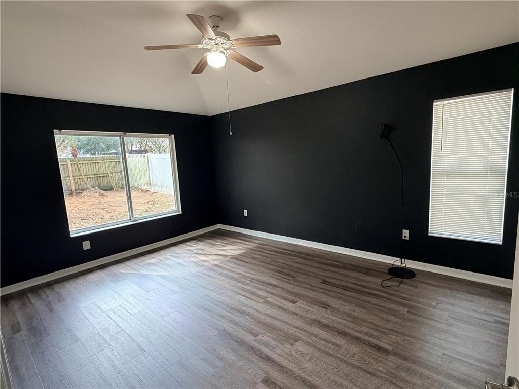 4111 Amber Ridge Lane Valrico, FL 33594 - Photo 15 of 27 a view of an empty room with wooden floor and a window