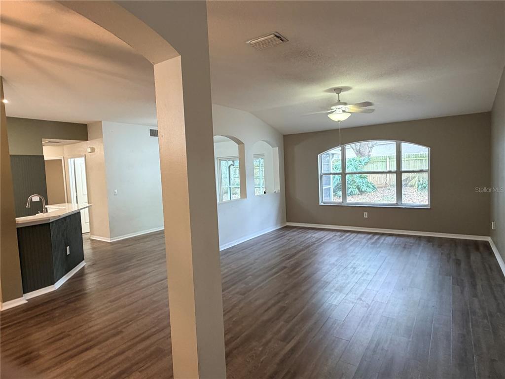 4111 Amber Ridge Lane Valrico, FL 33594 - Photo 2 of 27 wooden floor in an empty room with a window