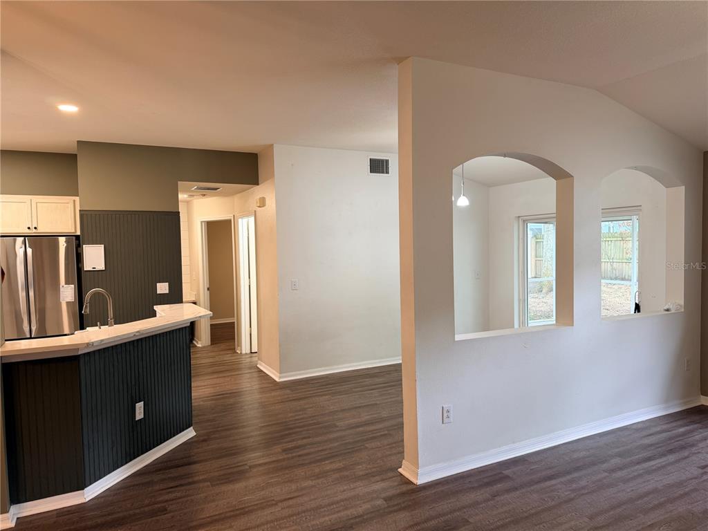 4111 Amber Ridge Lane Valrico, FL 33594 - Photo 4 of 27 a view of an empty room with wooden floor and a cabinet