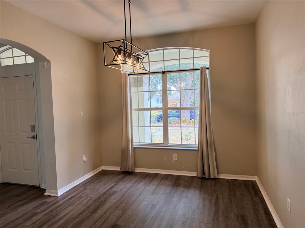 4111 Amber Ridge Lane Valrico, FL 33594 - Photo 6 of 27 a view of empty room with wooden floor and fan