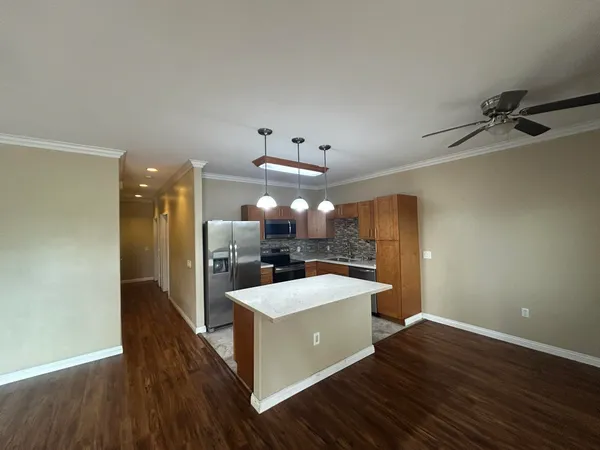 a large kitchen with a table and chairs